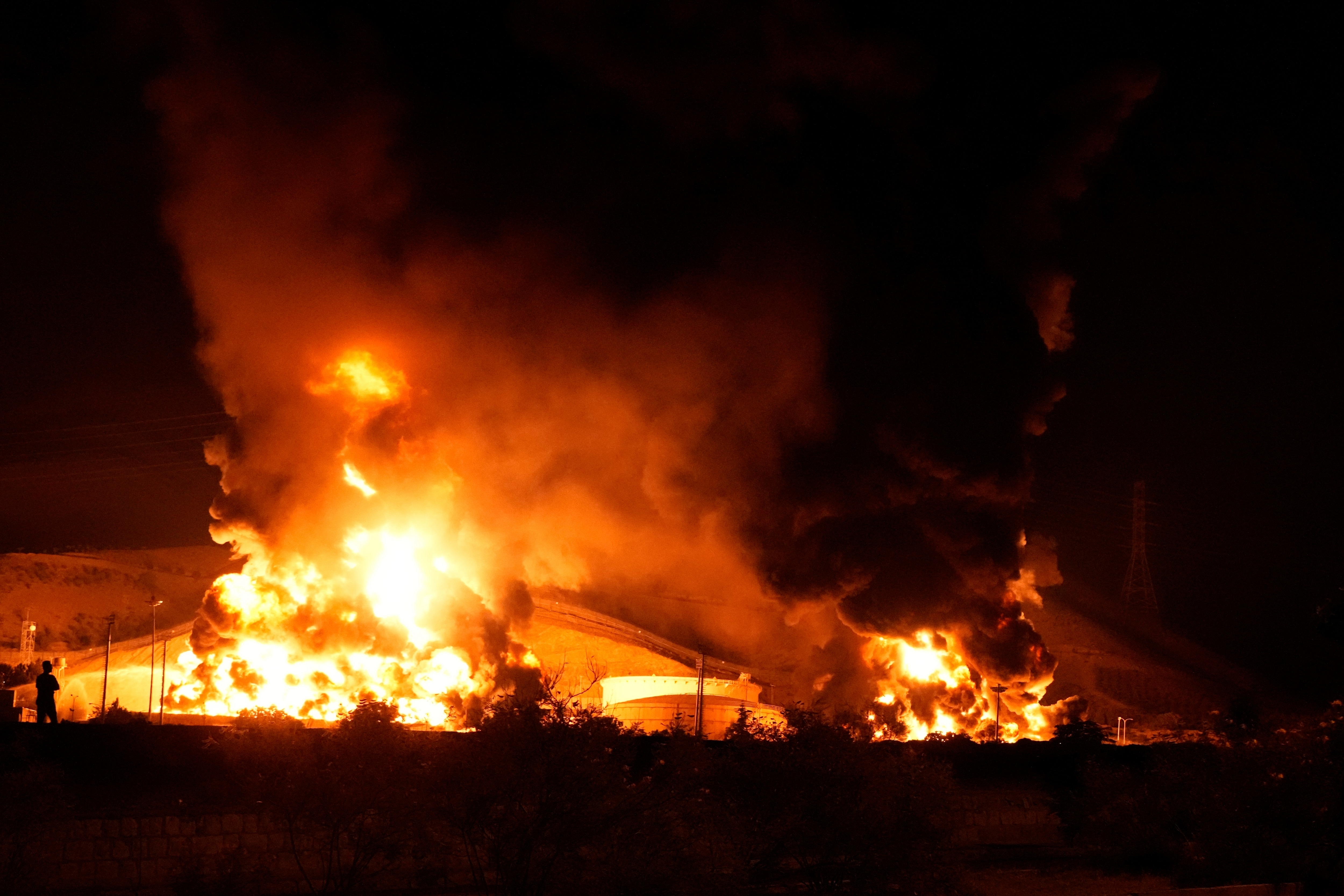 Flames rise from an oil storage facility after it appeared to have been struck by an Israeli missile in Tehran, Iran, early Sunday, June 15, 2025.  (AP)