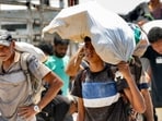 Displaced Palestinians receive humanitarian aid packages from a US-backed foundation in Rafah in the southern Gaza Strip 