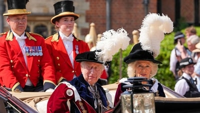 Britain's King Charles III and Britain's Queen Camilla travelling in a horse-drawn carriage as they leave after the Order of the Garter service at St George's Chapel in Windsor Castle, southern England, on June 16, 2025. (AFP) Britain's King Charles III and Britain's Queen Camilla travelling in a horse-drawn carriage as they leave after the Order of the Garter service at St George's Chapel in Windsor Castle, southern England, on June 16, 2025. (AFP)