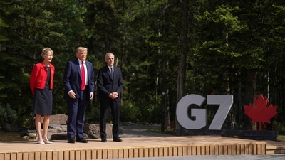President Donald Trump, centre, poses for photos with Canadian Prime Minister Mark Carney, right, and his wife Diana Fox during the official welcoming to the G7 Summit in Kananaskis, Alberta, Canada, Monday, June 16, 2025. (Darryl Dyck/The Canadian Press via AP) (AP) President Donald Trump, centre, poses for photos with Canadian Prime Minister Mark Carney, right, and his wife Diana Fox during the official welcoming to the G7 Summit in Kananaskis, Alberta, Canada, Monday, June 16, 2025. (Darryl Dyck/The Canadian Press via AP) (AP)