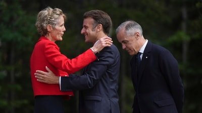 Canadian Prime Minister Mark Carney, back right, and his wife Diana Fox Carney, left, welcome French President Emmanuel Macron to the G7 Summit in Kananaskis, Alberta, Canada, Monday, June 16, 2025. (Darryl Dyck/The Canadian Press via AP) (AP) Canadian Prime Minister Mark Carney, back right, and his wife Diana Fox Carney, left, welcome French President Emmanuel Macron to the G7 Summit in Kananaskis, Alberta, Canada, Monday, June 16, 2025. (Darryl Dyck/The Canadian Press via AP) (AP)