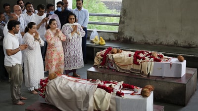 Family members offer prayer next to the bodies of Dilip Patel and his wife Meena Patel, who died in the Air India Boeing 787-8 Dreamliner plane carsh during take-off from an airport, in Ahmedabad (REUTERS)