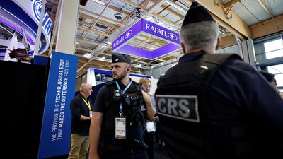 French police secure the area in front of the closed IAI and RAFAEL stands after the four main Israeli company stands at the Paris Airshow were shut down (REUTERS)