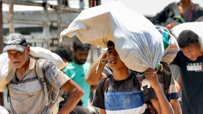 Displaced Palestinians receive humanitarian aid packages from a US-backed foundation in Rafah in the southern Gaza Strip (AFP)