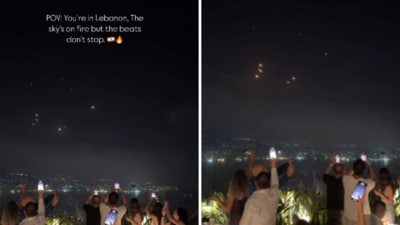 The Lebanese diners filmed the missiles raining down on Israel on their phones. (Instagram/placesbyalaa ) The Lebanese diners filmed the missiles raining down on Israel on their phones. (Instagram/placesbyalaa )
