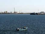 A speed boat passes by oil docks at the port of Kalantari in the city of Chabahar, east of the Strait of Hormuz. 