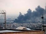 Smoke billows from an explosion near the Azadi Tower in Tehran on June 16, 2025 after Israeli strikes. The Islamic Republic of Iran Broadcasting (IRIB) building was struck in an Israeli attack on Monday, cutting live coverage immediately.