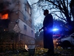 A resident looks at an apartment building in Kyiv damaged during a Russian strike on Ukraine on June 17. 