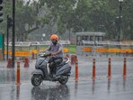 A commuter passes through during heavy rainfall, in New Delhi on Sunday. A commuter passes through during heavy rainfall, in New Delhi on Sunday.