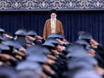 Iran's Supreme Leader Ayatollah Ali Khamenei listens to the national anthem as Air Force officers salute during their meeting in Tehran, Iran