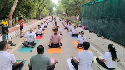 At the yoga session on Tuesday, Yoga instructors led the participants through a common yoga protocol and explained the health benefits through interactive sessions. (HT Photos)
