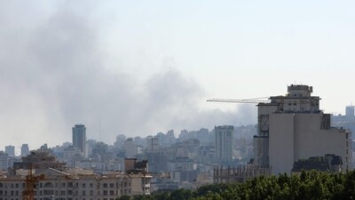 Smoke plumes arise from the Islamic Republic of Iran Broadcasting (IRIB) corporation building in the north of Tehran after it was hit by an overnight Israeli strike on June 17, 2025. (AFP)
