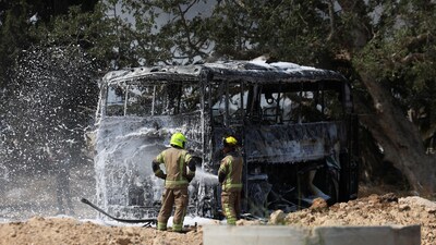 Iran-Israel War: Firefighters work to extinguish a fire on a bus following a missile attack from Iran in Herzliya on Tuesday. (REUTERS)