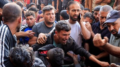 Iran-Israel War: Palestinians react next to people wounded in an Israeli strike while waiting for aid, according to the Gaza Health Ministry, at Nasser hospital, in Khan Younis, southern Gaza Strip. (REUTERS)
