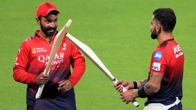 Dinesh Karthik, left, seen having a word with Virat Kohli (PTI) Dinesh Karthik, left, seen having a word with Virat Kohli (PTI)