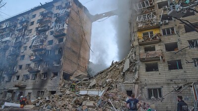 Firefighters put out the fire after a Russian missile hit a residential building in Kyiv on Tuesday. (AP) Firefighters put out the fire after a Russian missile hit a residential building in Kyiv on Tuesday. (AP)
