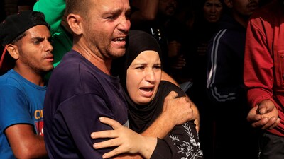 Iran-Israel War: People react as Palestinian casualties, who were waiting to receive aid, are brought into Nasser hospital following an Israeli strike, according to the Gaza Health Ministry, in Khan Younis, southern Gaza Strip. (REUTERS)