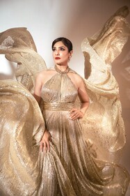 Outfit: Suneet Varma | Jewellery: Shailja’s Fine Jewellery | Raveena shimmers in this gold sequined dress with a halter neckline. Taking things up a notch is the long train of the dress and a pair of diamond earrings set in gold. (Photo: Deepak Das) Outfit: Suneet Varma | Jewellery: Shailja’s Fine Jewellery | Raveena shimmers in this gold sequined dress with a halter neckline. Taking things up a notch is the long train of the dress and a pair of diamond earrings set in gold. (Photo: Deepak Das)