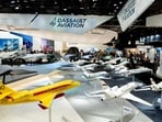 Display models of Dassault Aviation SA aircraft, including Falcon firefighter and executive jets at the Paris Air Show in Paris, France.