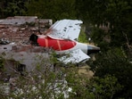 Tail of an Air India Boeing 787 Dreamliner plane that crashed is seen stuck on a building after the incident in Ahmedabad.