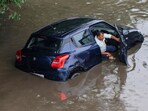 A viral image showed a man in distress as his car got stuck on a waterlogged Gurgaon road, following heavy downpour. A viral image showed a man in distress as his car got stuck on a waterlogged Gurgaon road, following heavy downpour.