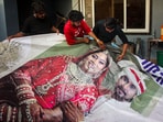 Raja Raghuvanshi's family members, cut out the picture of his wife Sonam Raghuvanshi from a poster of their marriage. Raja Raghuvanshi's family members, cut out the picture of his wife Sonam Raghuvanshi from a poster of their marriage.