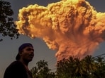 TOPSHOT - A villager watches the eruption of Mount Lewotobi Laki-Laki as seen from Talibura village in Sikka, East Nusa Tenggara, on June 17, 2025. A volcano in eastern Indonesia spewed a colossal ash tower into the sky on June 17, authorities said, after they raised its alert level to the highest of a four-tiered system. (Photo by AFP) TOPSHOT - A villager watches the eruption of Mount Lewotobi Laki-Laki as seen from Talibura village in Sikka, East Nusa Tenggara, on June 17, 2025. A volcano in eastern Indonesia spewed a colossal ash tower into the sky on June 17, authorities said, after they raised its alert level to the highest of a four-tiered system. (Photo by AFP)