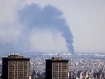 Smoke billows in the distance from an oil refinery following an Israeli strike on the Iranian capital Tehran. Smoke billows in the distance from an oil refinery following an Israeli strike on the Iranian capital Tehran.