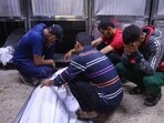 People mourn by the body of Palestinians who were killed a day earlier in Israeli fire while seeking food aid, at Al-Shifa hospital morgue in Gaza City People mourn by the body of Palestinians who were killed a day earlier in Israeli fire while seeking food aid, at Al-Shifa hospital morgue in Gaza City
