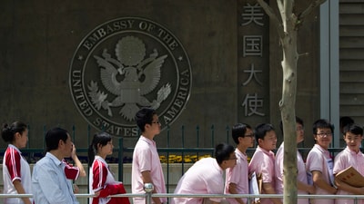 Chinese students wait outside the U.S. Embassy for their visa application interviews, in Beijing on May 2, 2012. (AP File) Chinese students wait outside the U.S. Embassy for their visa application interviews, in Beijing on May 2, 2012. (AP File)