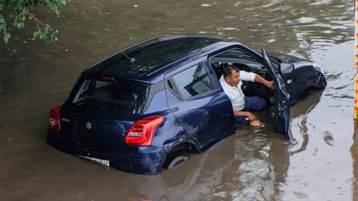A viral image showed a man in distress as his car got stuck on a waterlogged Gurgaon road, following heavy downpour. (PTI)