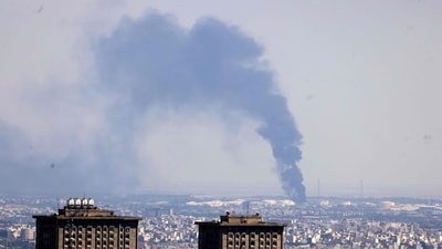 Smoke billows in the distance from an oil refinery following an Israeli strike on the Iranian capital Tehran. (AFP)