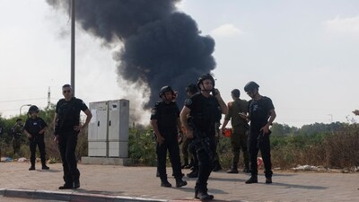 Iran Israel war news Highlights: Israeli police officers near smoke from an Iranian missile strike in Hertzliya, Israel, where Iran allegedly struck Mossad's centre. (Bloomberg) Iran Israel war news Highlights: Israeli police officers near smoke from an Iranian missile strike in Hertzliya, Israel, where Iran allegedly struck Mossad's centre. (Bloomberg)