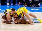 Oklahoma City Thunder guard Shai Gilgeous-Alexander (2) grabs a loose ball as Indiana Pacers guard T.J. McConnell (9) and guard Andrew Nembhard (2) battle for control during the third quarter in game five of the 2025 NBA Finals at Paycom Center. 