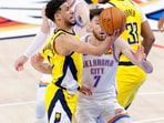 Indiana Pacers guard Tyrese Haliburton (0) drives to the basket past Oklahoma City Thunder forward Chet Holmgren (7) during the fourth quarter in game five of the 2025 NBA Finals at Paycom Center.