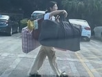 A Chinese student inspired many after walking home with quilts balanced on a bamboo pole post-exam. A Chinese student inspired many after walking home with quilts balanced on a bamboo pole post-exam.