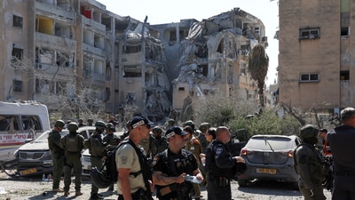 Emergency personnel work at an impact site following a missile strike from Iran on Israel, in Holon, Israel June 19, 2025. (Reuters)