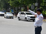 A Delhi Traffic Police personnel controls traffic in the national capital. (ANI file) A Delhi Traffic Police personnel controls traffic in the national capital. (ANI file)