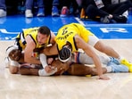 Oklahoma City Thunder guard Shai Gilgeous-Alexander (2) grabs a loose ball as Indiana Pacers guard T.J. McConnell (9) and guard Andrew Nembhard (2) battle