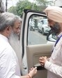 Congress candidate Bharat Bhushan Ashu interacting with Shiromani Akali Dal candidate Parupkar Singh Ghuman outside a polling booth in Ludhiana on Thursday. (Gurpreet Singh/HT)