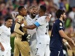 John #12, Alexander Barboza #20, and Marlon Freitas #17 of Botafogo celebrate following the team's victory as Khvicha Kvaratskhelia #7 of Paris Saint-Germain looks on the FIFA Club World Cup 2025
