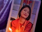 A woman holds a portrait of Lamnunthem Singson, an air hostess who died in the Air India place crash in Ahmedabad, during a candlelight prayer service. A woman holds a portrait of Lamnunthem Singson, an air hostess who died in the Air India place crash in Ahmedabad, during a candlelight prayer service.