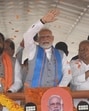 Prime Minister Narendra Modi waves to the crowd on his way to address a public rally with Bihar Chief Minister Nitish Kumar and Deputy Chief Minister Samrat Choudhary in Siwan, Bihar. (Santosh Kumar/HT)