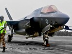 A CISF personnel stand guard near the British F-35 fighter jet that made an emergency landing after running low on fuel at the Thiruvananthapuram International Airport on Saturday night. A CISF personnel stand guard near the British F-35 fighter jet that made an emergency landing after running low on fuel at the Thiruvananthapuram International Airport on Saturday night.