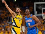 Indiana Pacers guard Tyrese Haliburton (0) motions next to Oklahoma City Thunder forward Jalen Williams (8)