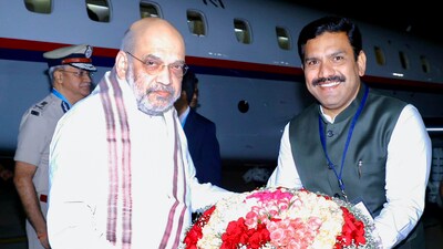 Union Home Minister Amit Shah being received by Karnataka BJP President BY Vijayendra on his arrival, in Bengaluru on Thursday. (@AmitShah X)