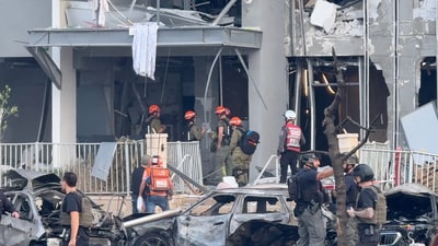 Emergency services officials inspect damage to buildings hit following a missile strike from Iran, in Be'er Sheva, Israel June 20, 2025 (Reuters)