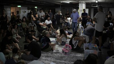 People take shelter as air raid sirens warn of incoming Iranian strikes in Tel Aviv, Israel, Friday, June 20, 2025. (AP) People take shelter as air raid sirens warn of incoming Iranian strikes in Tel Aviv, Israel, Friday, June 20, 2025. (AP)