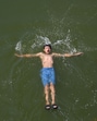 A boy swims in a Dal Lake on a hot day in Srinagar on Friday. (Waseem Andrabi /HT) A boy swims in a Dal Lake on a hot day in Srinagar on Friday. (Waseem Andrabi /HT)