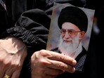 A demonstrator holds a picture of Iran's Supreme Leader Ayatollah Ali Khamenei as people gather for a rally in solidarity with Iran after Friday prayers, amid the Iran-Israel conflict, in Beirut's southern suburbs, Lebanon.